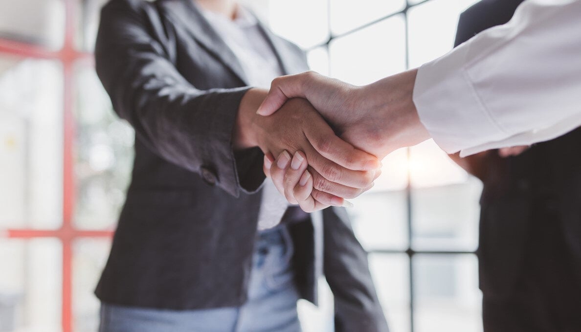 Job candidate shakes hand with hiring manager