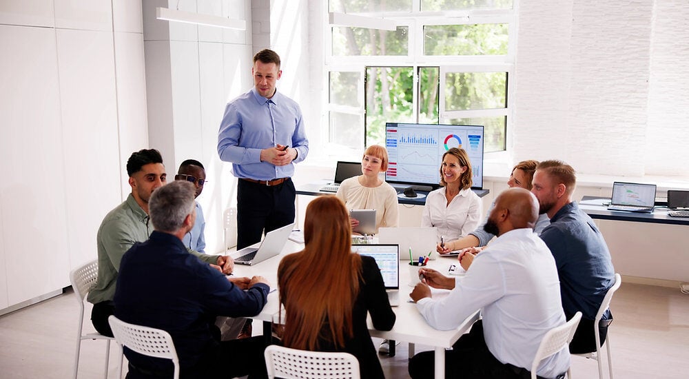 Leader guiding a strategic leadership development session in bright meeting room